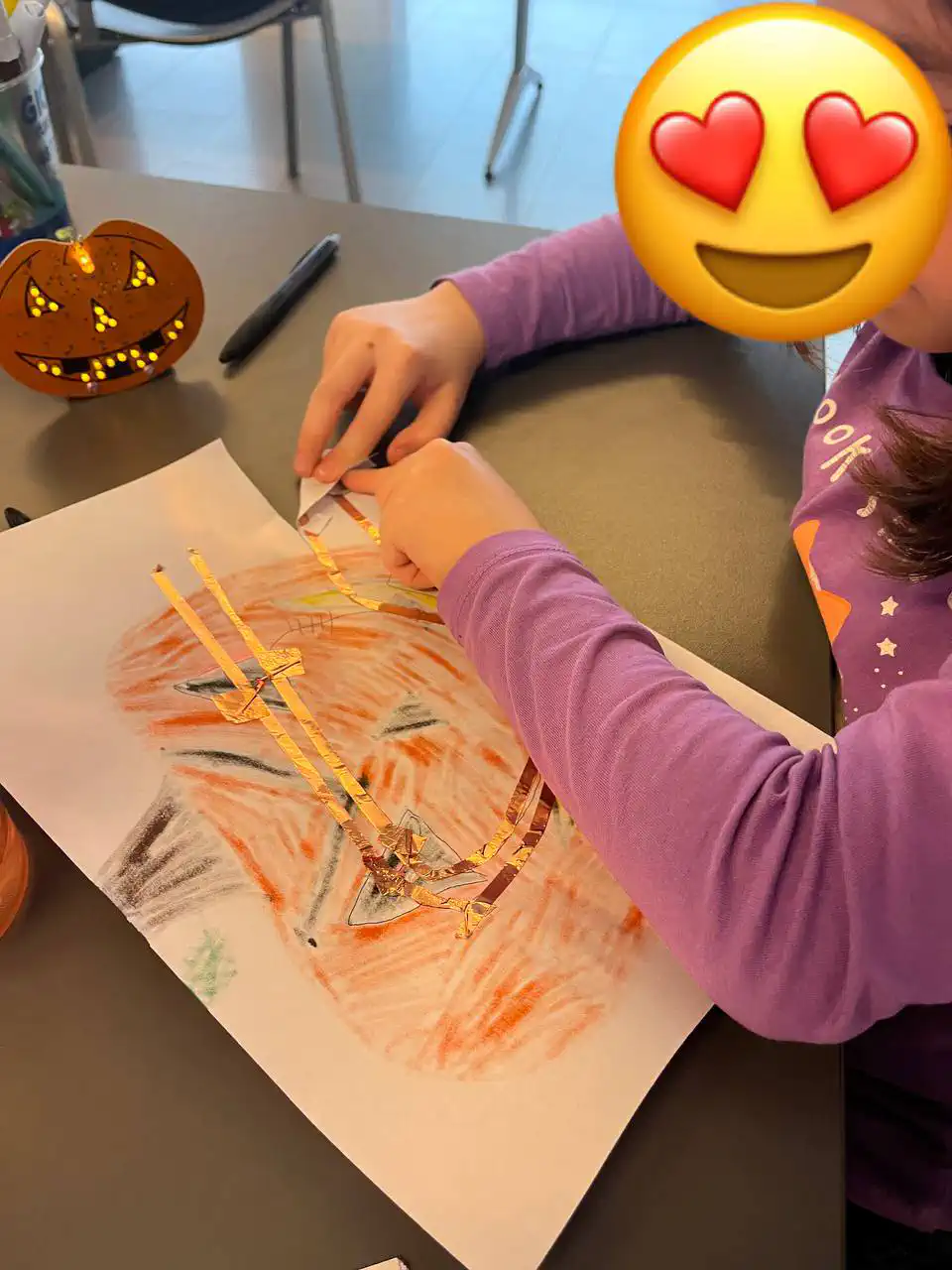 Una foto in cui una bambina sta sistemando la propria zucca